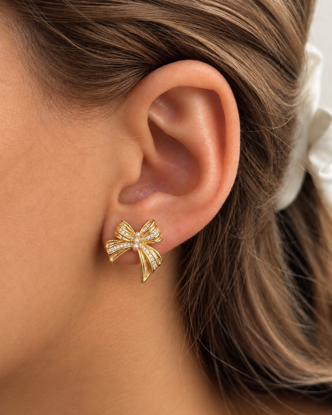 Clear stone ribbon bow earrings